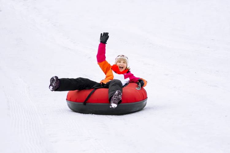 person snow tubing down a hill