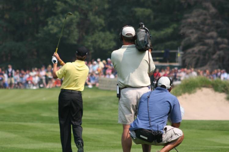 Camera crew filing a golfer tee off