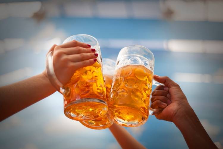 group of three cheers beer at Oktoberfest celebration